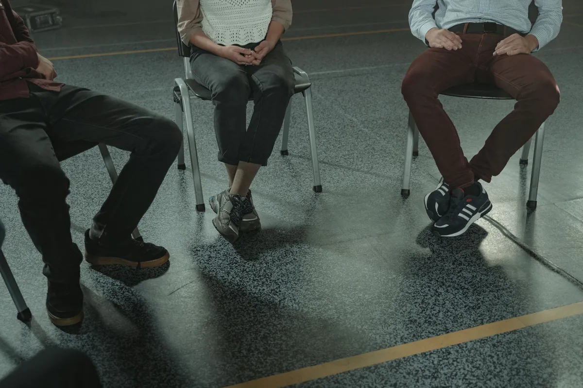 Chairs arranged in a circle in a quiet room, seen at floor level