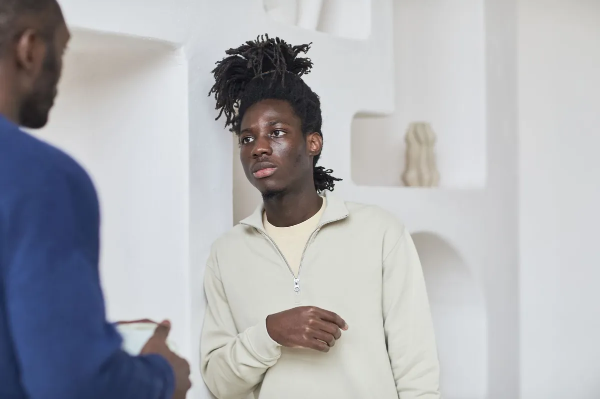 Two men in close conversation, one listening carefully to the other