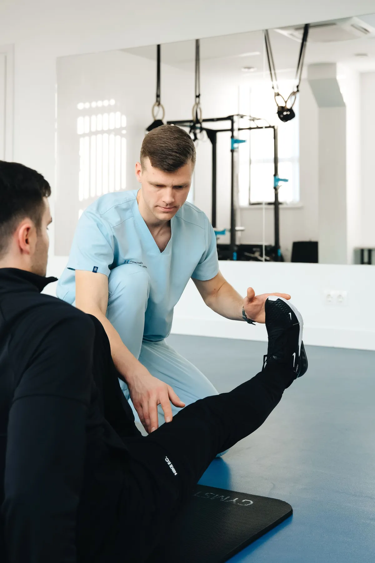 A physical therapist guiding a patient through a stretching exercise