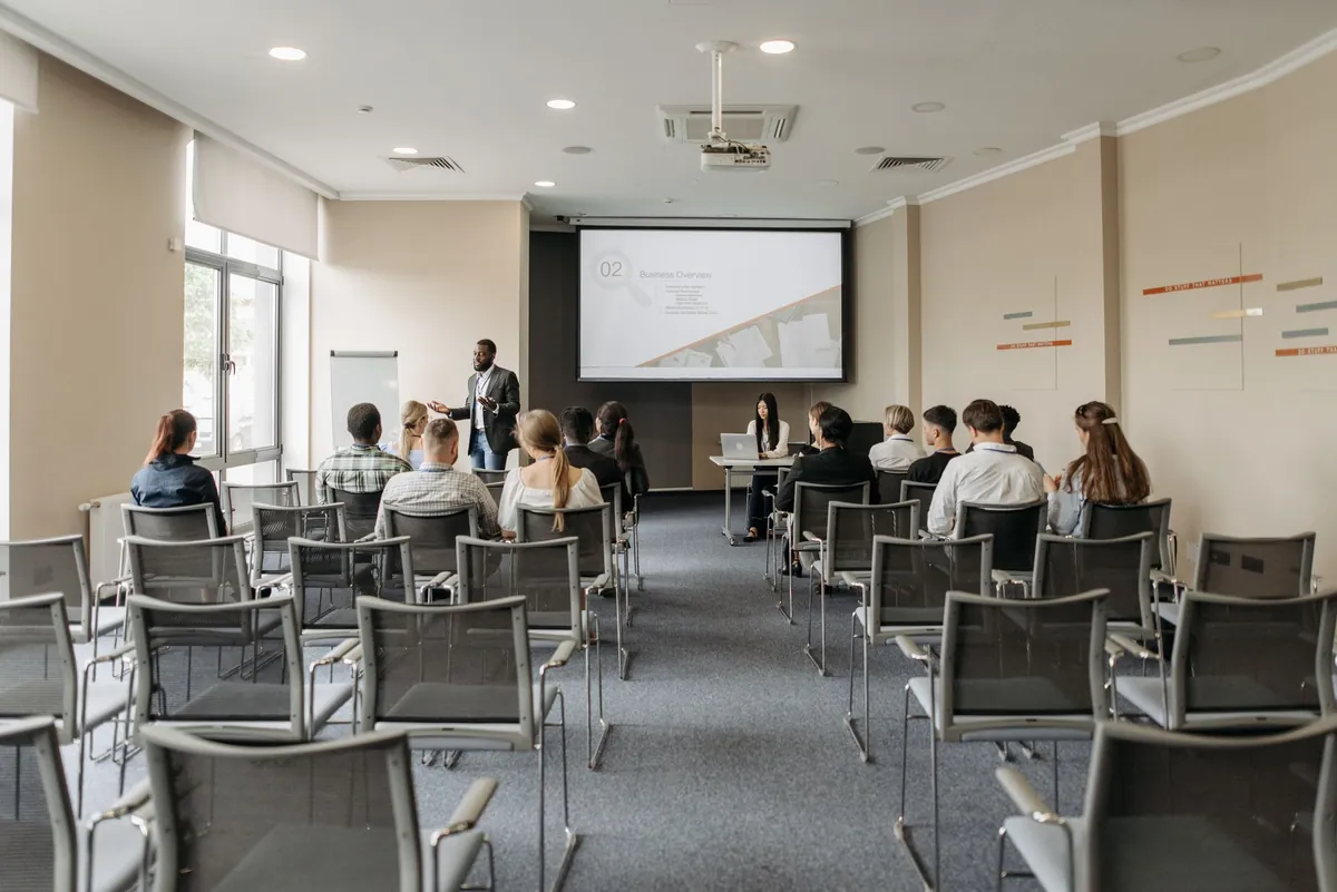 A seminar room set up with rows of chairs and a presentation screen